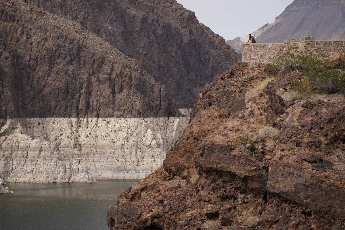 In this Aug. 13, 2021, file photo, a person looks out over Lake Mead near Hoover Dam at the Lak ...