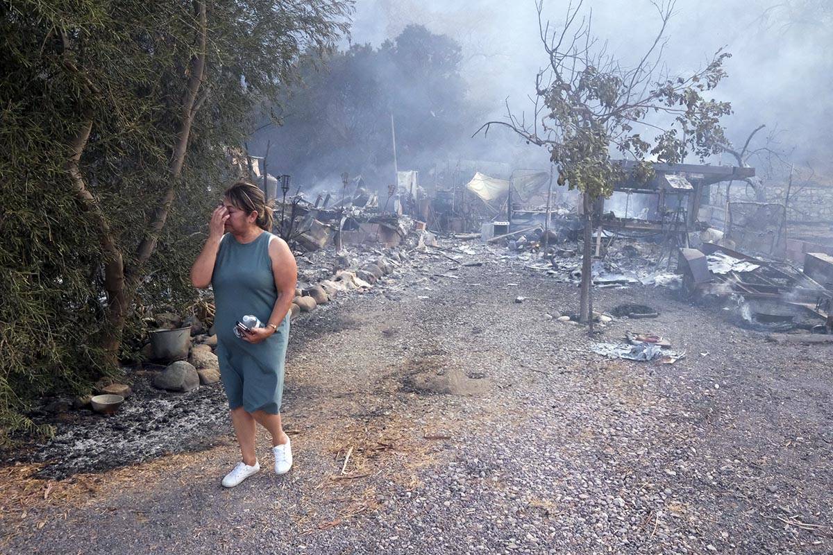 Homeowner Maria Covarrubias reacts after seeing her home burn down from the South Fire in Lytle ...