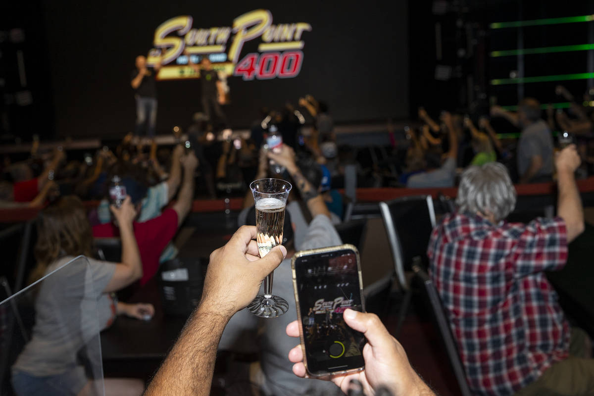 Fans toast to last year's South Point 400 champion, Kurt Busch, who is from Las Vegas, during a ...