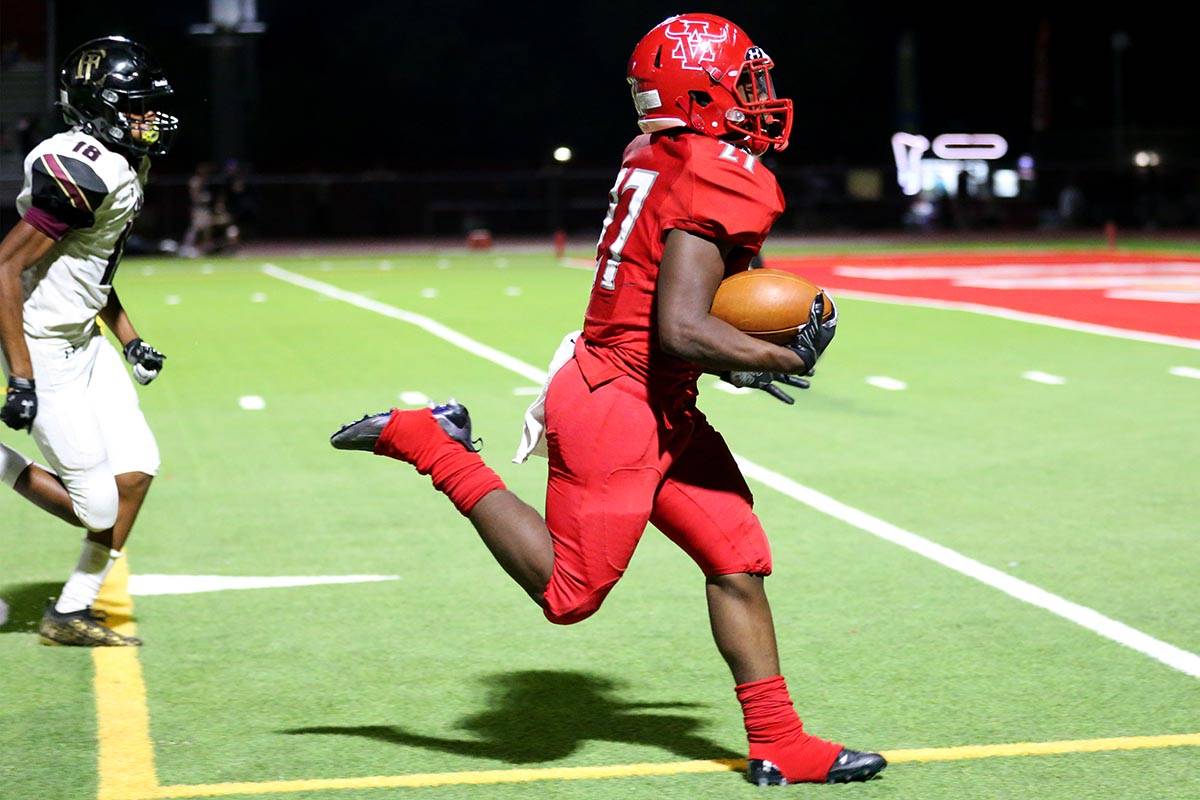 Arbor View's (27) runs for a touchdown as Faith Lutheran's Cam'ren-chance Brooks (18) runs behi ...