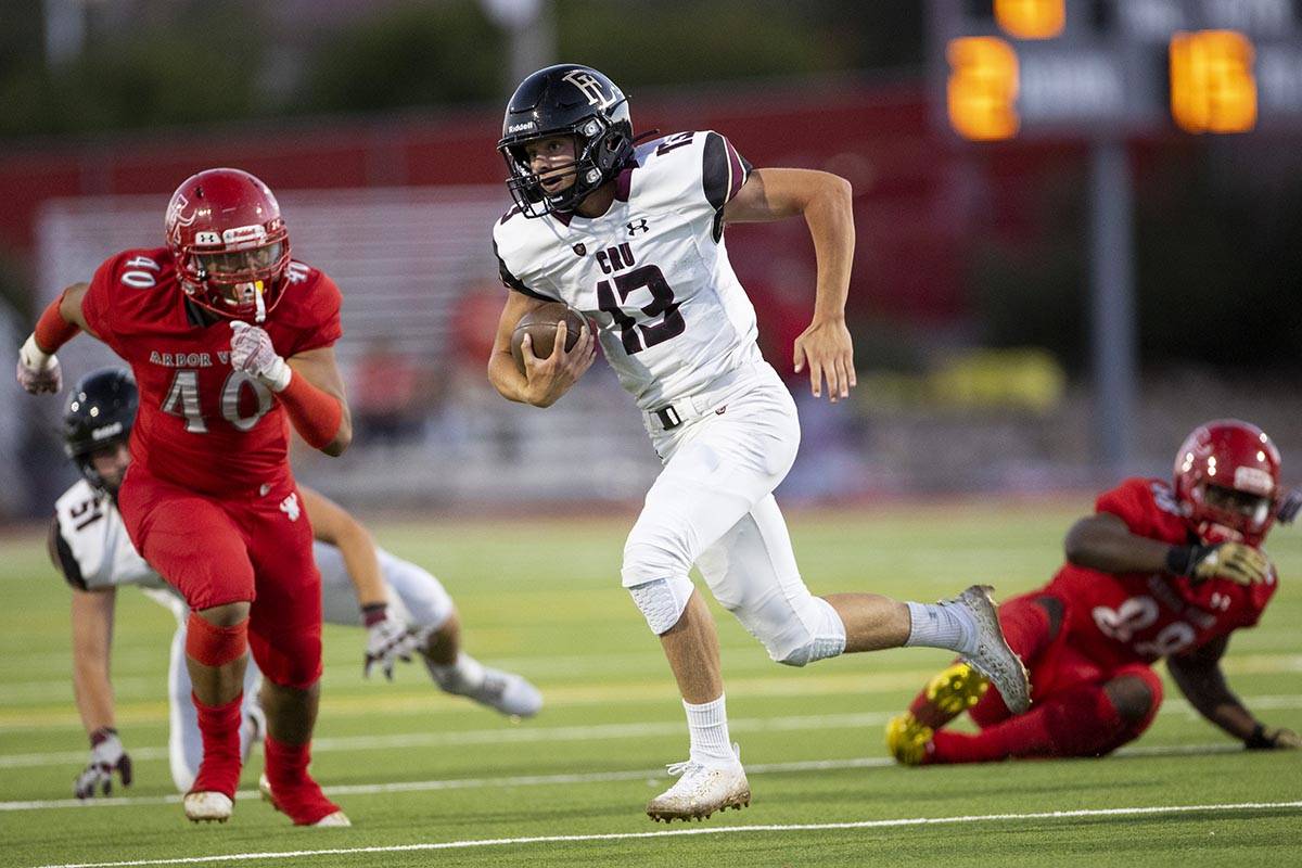 Faith Lutheran's Rylan Walter (13) runs the ball past Arbor View's Mario Rivas (40) during the ...