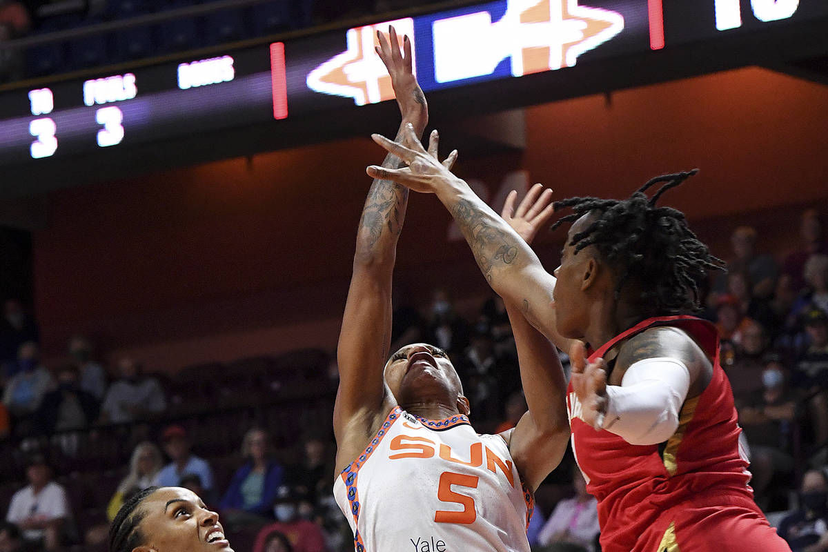 Connecticut Sun guard Jasmine Thomas (5) goes up for a shot against Las Vegas Aces' Riquna Will ...