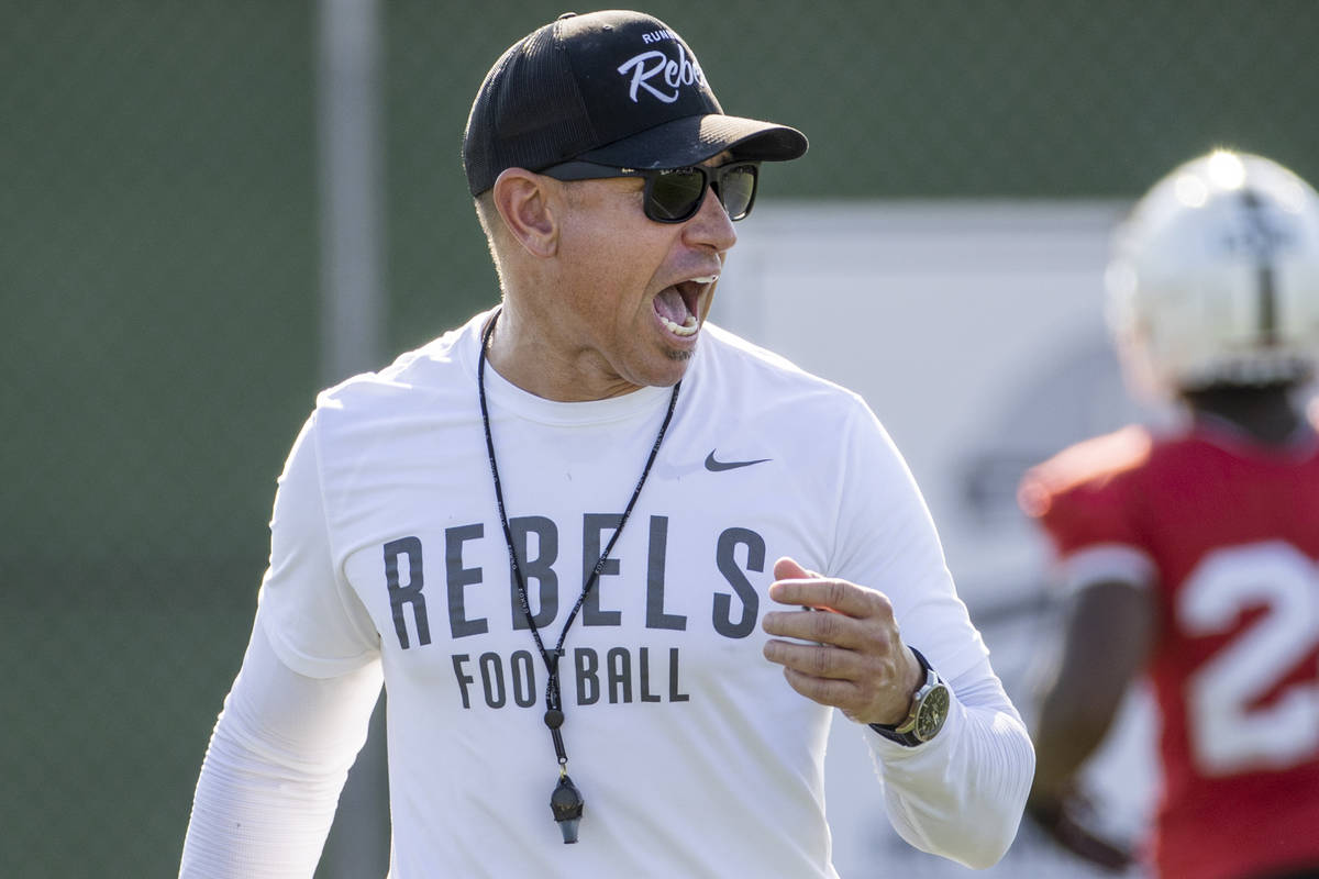 UNLV Head Coach Marcus Arroyo yells some encouragement to his players during a drill in footbal ...