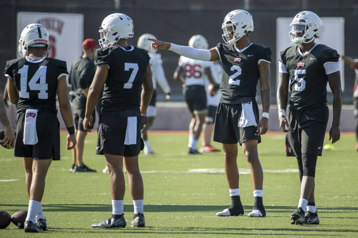 UNLV quarterbacks Jared Haywood (14), Cameron Friel (7), Doug Brumfield (2) and Justin Rog ...