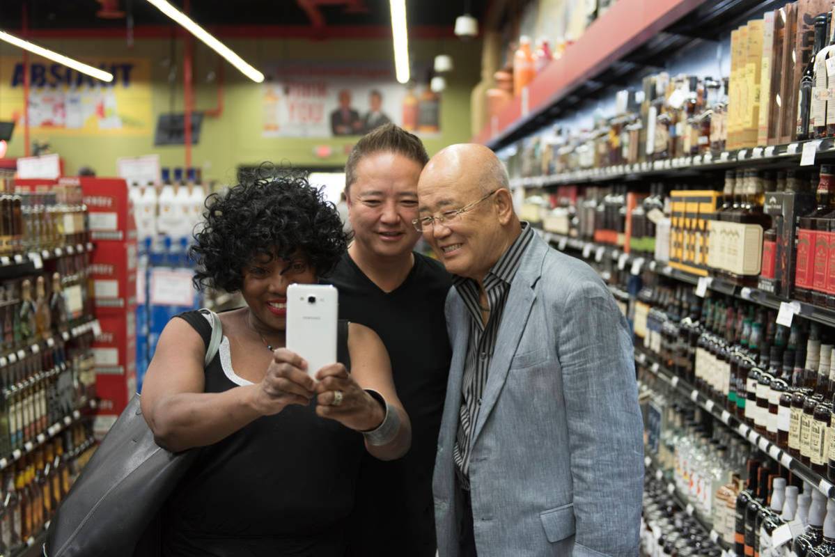 Rheata Porte, left, takes a selfie with Hae Un Lee, founder of Lee's Discount Liquor, right, an ...