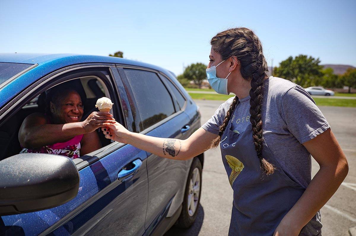 Gabrielle Holloway hands an ice cream to Kerry Nixon outside her family's Baskin Robbins in Hen ...