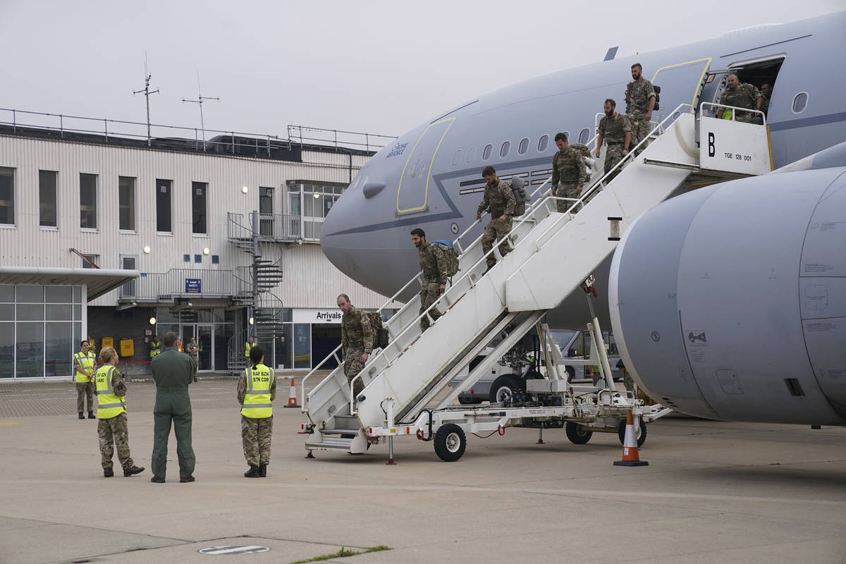 Members of the British armed forces 16 Air Assault Brigade disembark a flight from Afghanistan ...