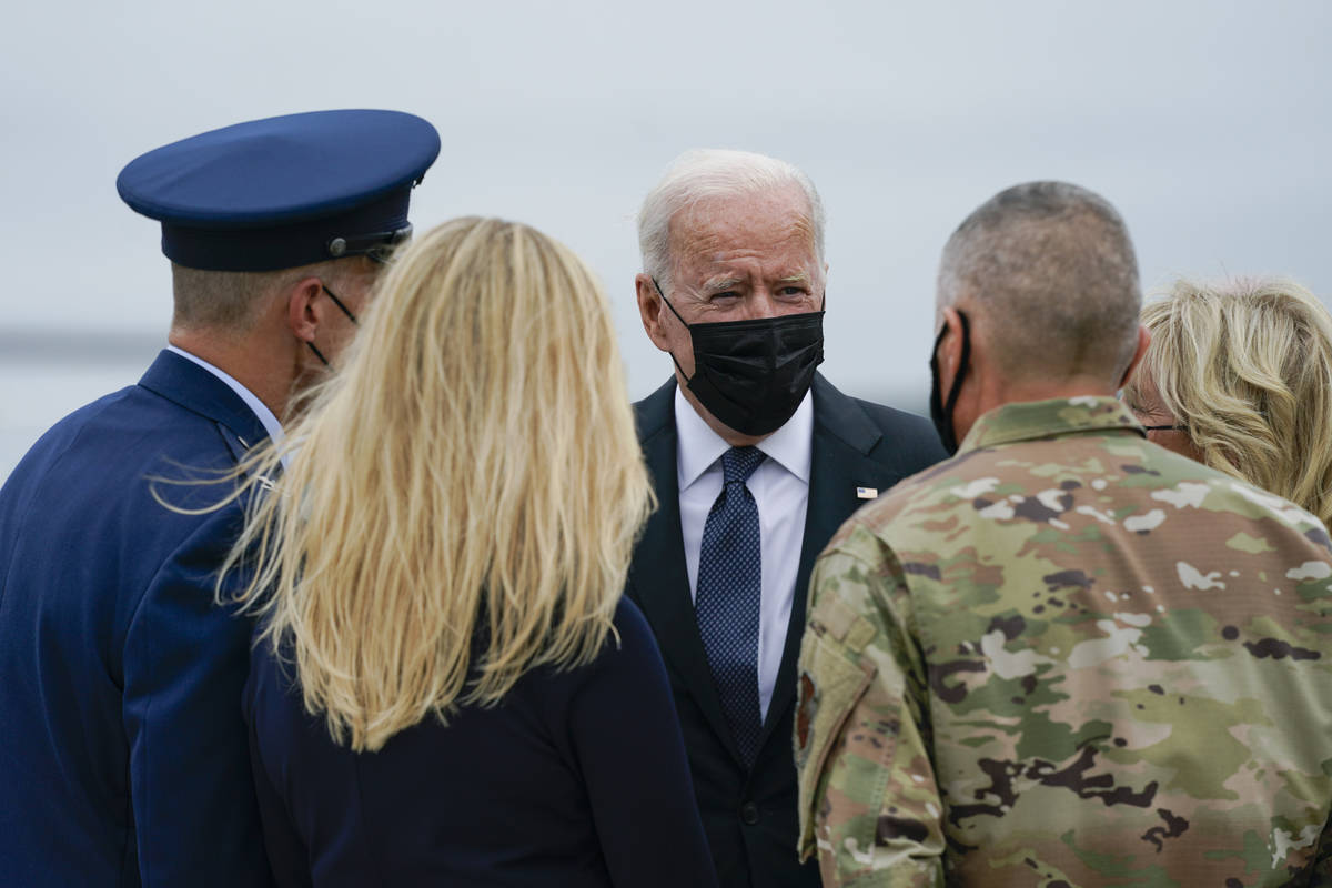 President Joe Biden and Jill Biden are greeted as they arrive at Dover Air Force Base, Del., Su ...