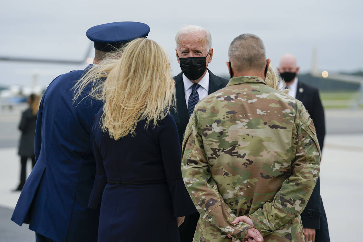President Joe Biden and Jill Biden are greeted as they arrive at Dover Air Force Base, Del., Su ...
