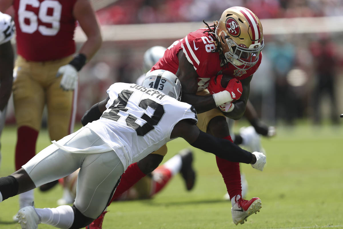 San Francisco 49ers running back Trey Sermon (28) runs against Las Vegas Raiders free safety Ka ...