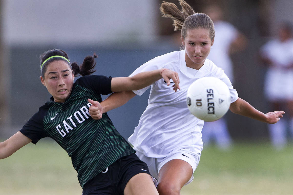 Green Valley's Samantha Orozco (4) falls as she passes while Foothill's Raquel Patalon (20) run ...