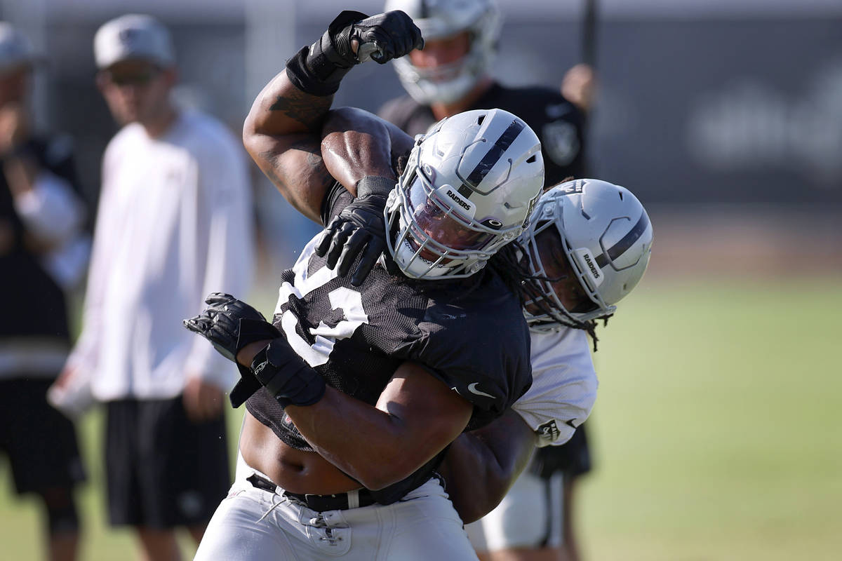 Las Vegas Raiders defensive end Kendal Vickers (93) breaks away from offensive guard John Simps ...