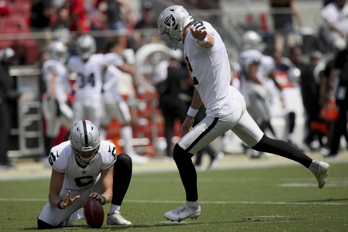 Las Vegas Raiders kicker Daniel Carlson (2) in action as punter A.J. Cole (6) holds the ball du ...