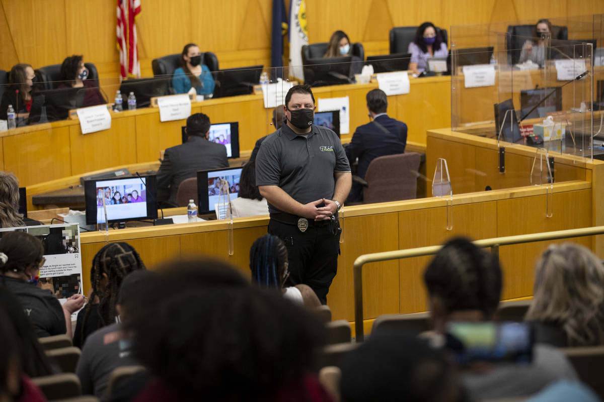 A security guard watches over a Clark County School District Board of Trustees meeting at the C ...