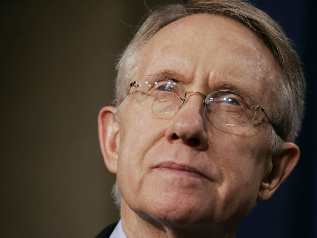 Senate Majority Leader Harry Reid, D-Nev., listens to a reporter's question during a news confe ...