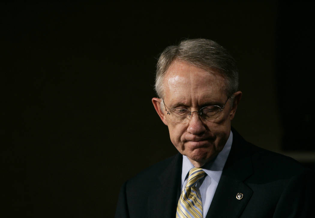 Senate Majority Leader Harry Reid, D-Nev., listens to a reporter's question during a news confe ...