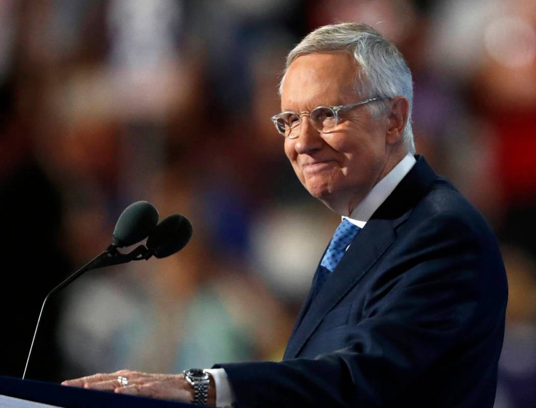 Senate Minority Leader Harry Reid of Nevada smiles from the podium as he speaks during the thir ...