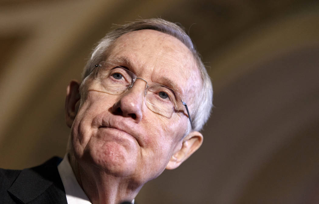 This April 8, 2014, file photo shows Senate Majority Leader Harry Reid of Nevada pausing during ...