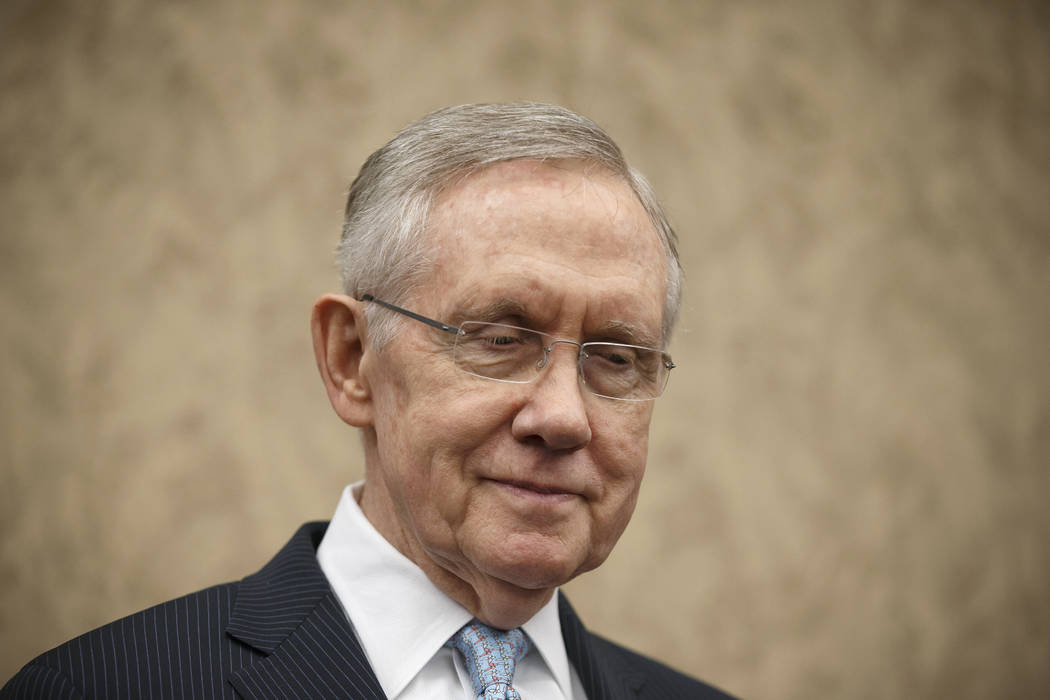 Senate Majority Leader Harry Reid, D-Nev., pauses before speaking to a room of low-wage workers ...