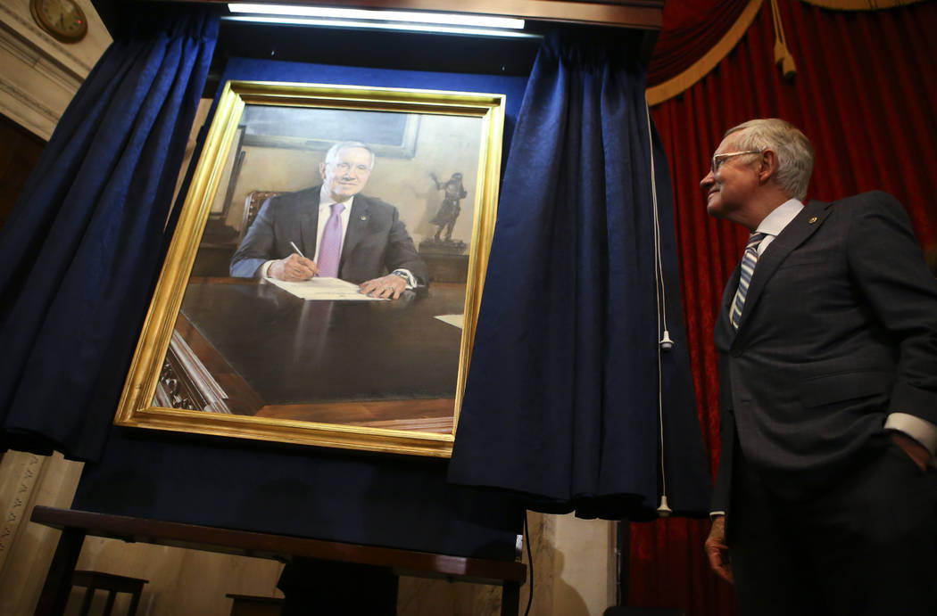 U.S. Senator Harry Reid, D-Nev., looks at a portrait of himself after it was unveiled during a ...