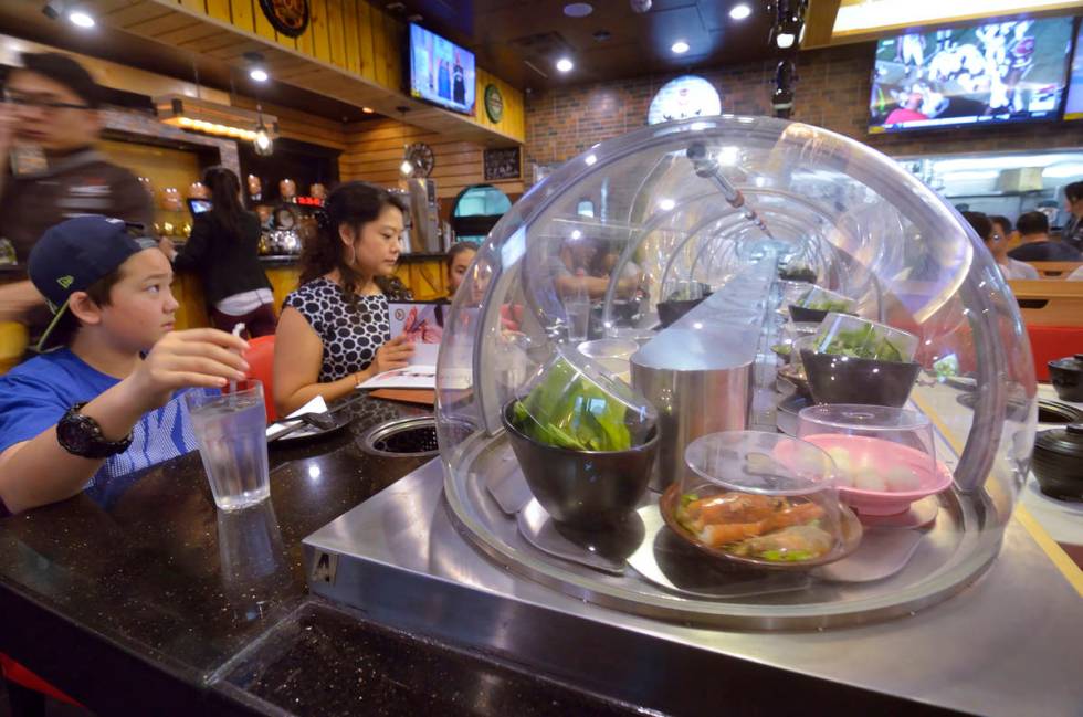A conveyor belt brings food directly to diners at the Chubby Cattle restaurant.(rjmagazine)