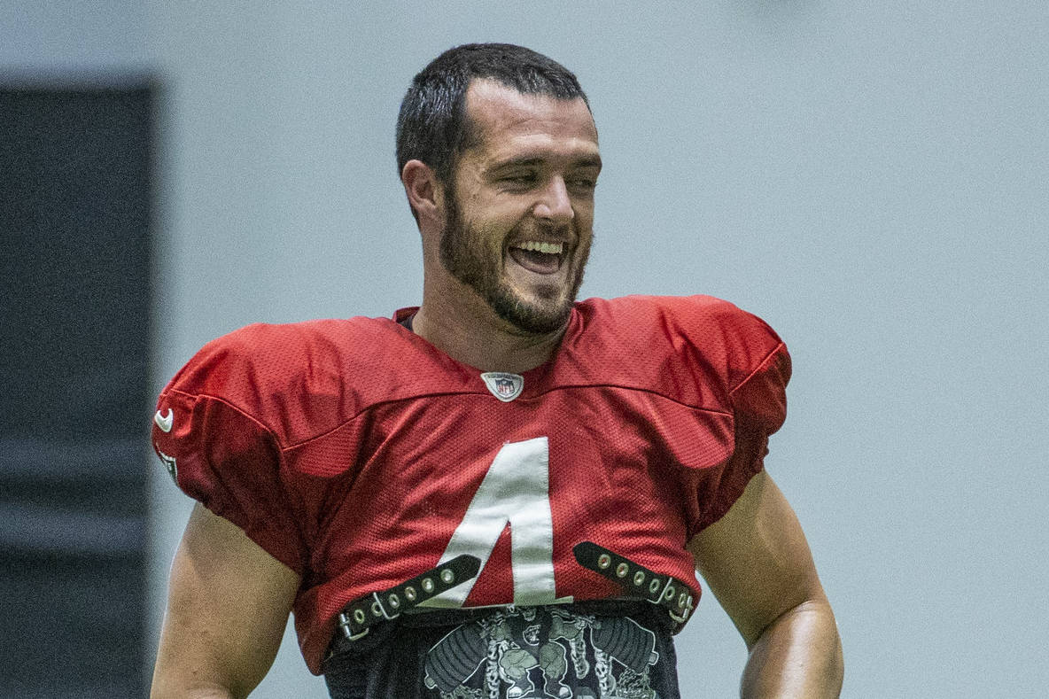Raiders quarterback Derek Carr (4) laughs with teammates during practice at the Intermountain H ...