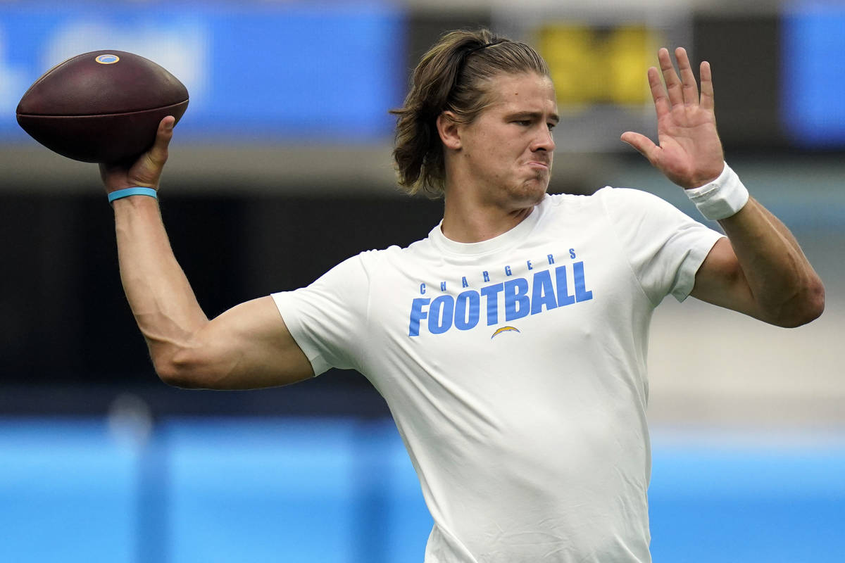 Los Angeles Chargers quarterback Justin Herbert warms up before a preseason NFL football game a ...