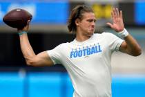 Los Angeles Chargers quarterback Justin Herbert warms up before a preseason NFL football game a ...