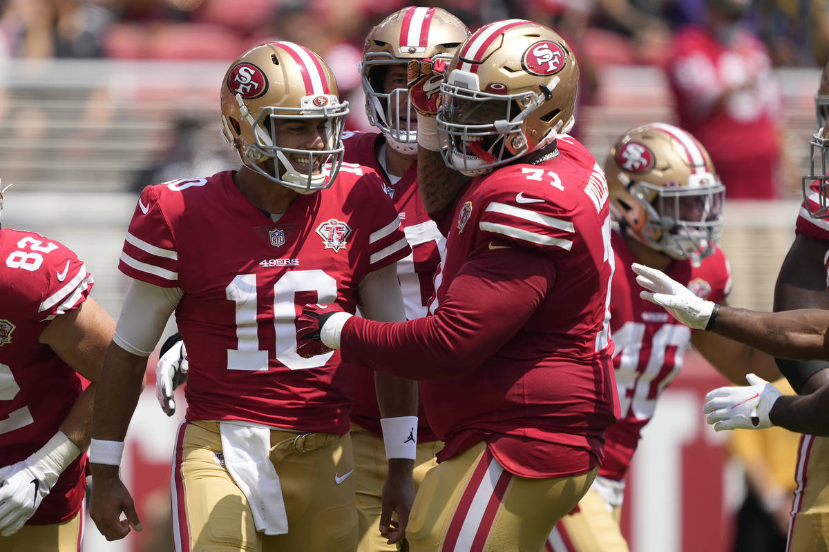 San Francisco 49ers quarterback Jimmy Garoppolo (10) celebrates with offensive tackle Trent Wil ...