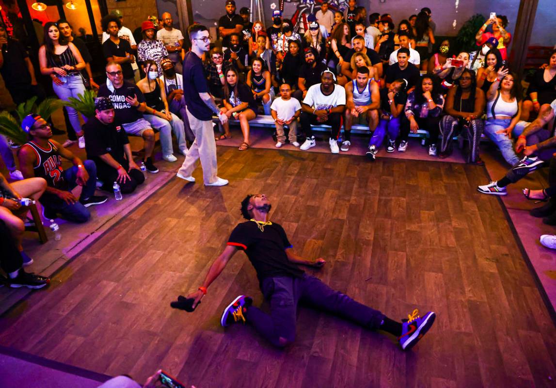 People compete in the dance battle at Ninja Karaoke during First Friday in the Arts District of ...