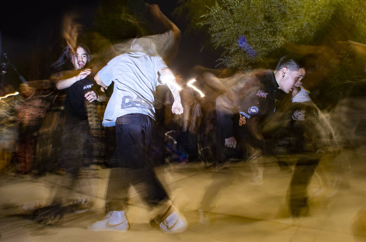 People mosh and dance as Ugly Boy, a band from east Las Vegas, performs during First Friday in ...