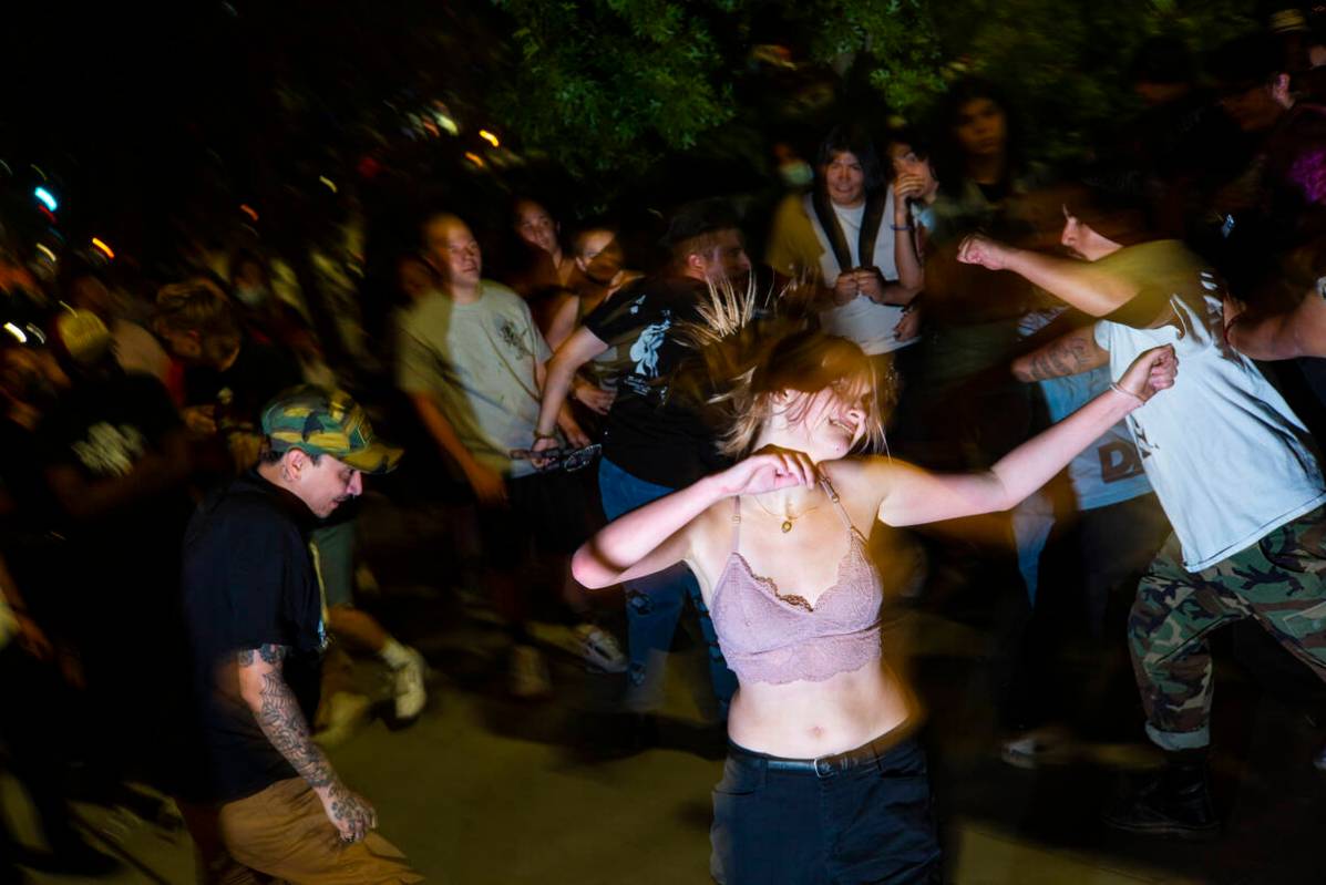 People mosh and dance as Ugly Boy, a band from east Las Vegas, performs during First Friday in ...