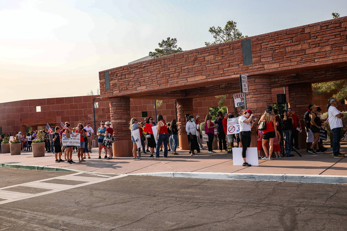 Concerned citizens wait in line for a Clark County School Board meeting regarding the possible ...