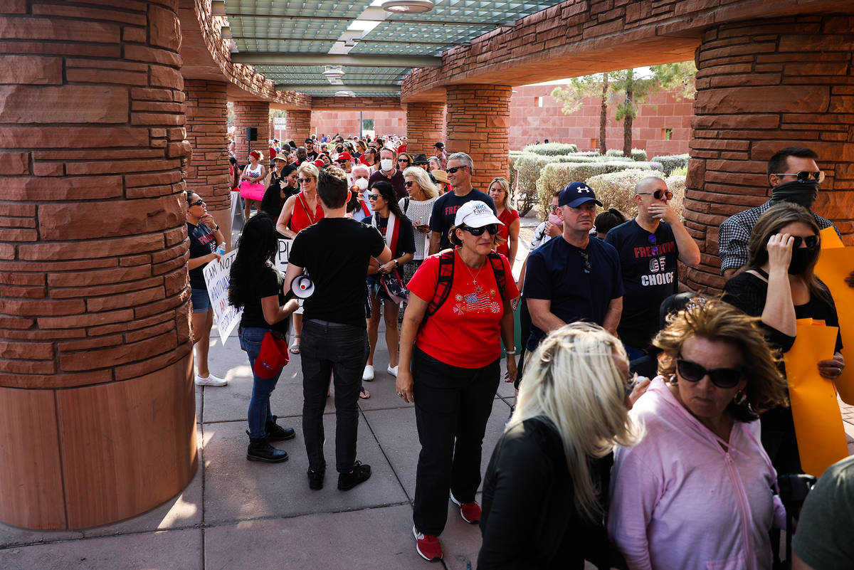 Concerned citizens wait in line for a Clark County School Board meeting regarding the possible ...