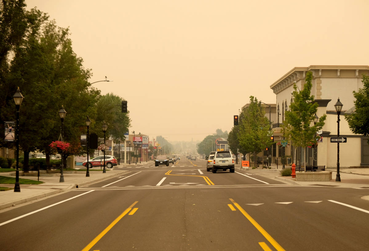 Downtown Carson City, looking south on Carson Street, is obscured by smoke drifting down from t ...