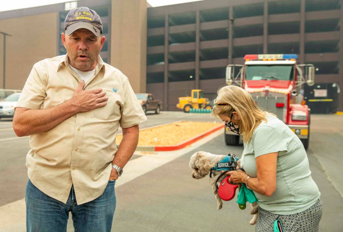 Jim, left, and Alicia Halloran with dog Billy Budd prepare to leave from the MontBleu now evacu ...