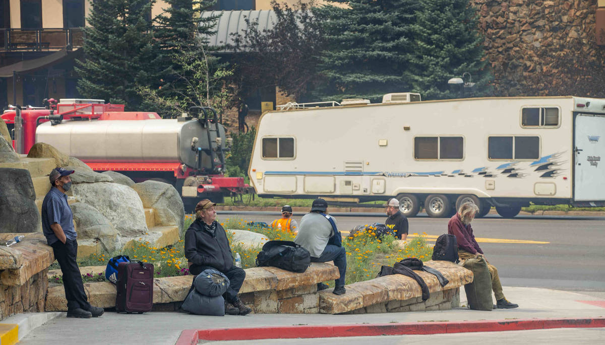 Guests sit outside awaiting a shuttle as the MontBleu is now evacuating due to the Caldor Fire ...