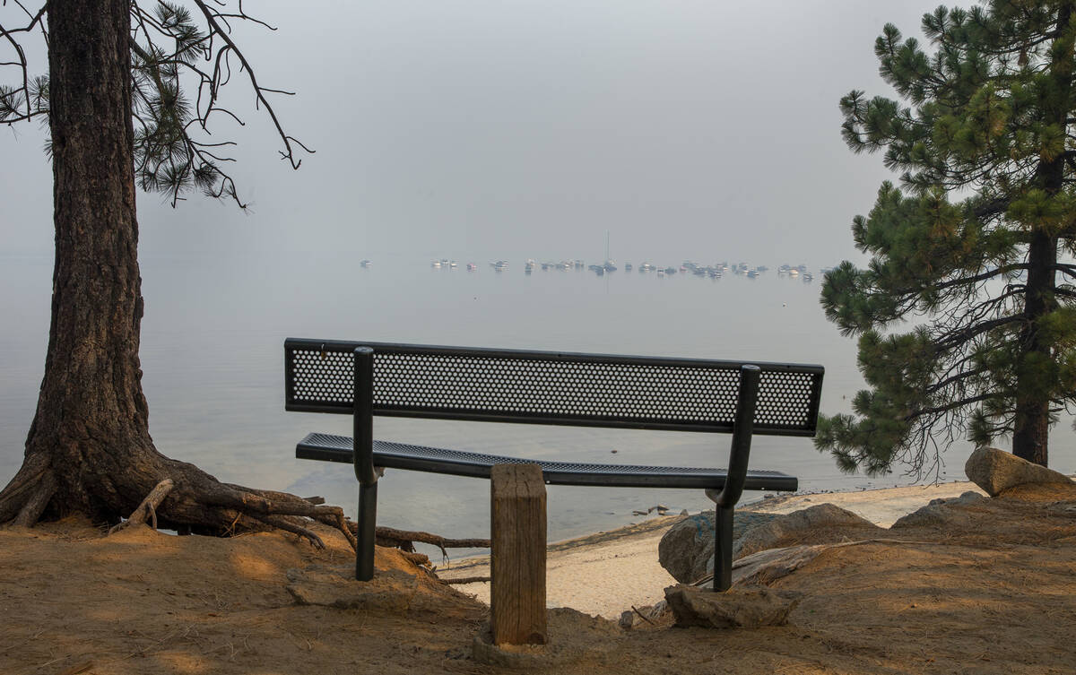 Boats are anchored off the shoreline on a smokey Lake Tahoe as the Caldor Fire continues to bur ...