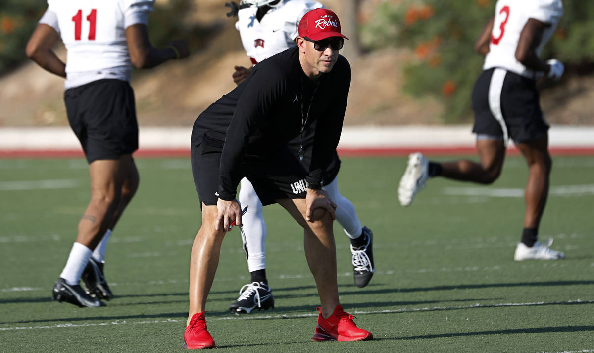 UNLV Rebels head coach Marcus Arroyo watches his players during football practice in UNLV, Wedn ...