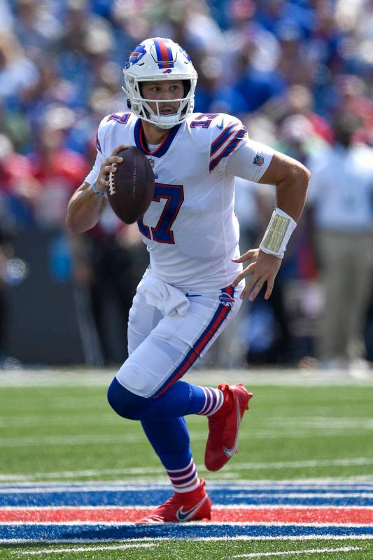 Buffalo Bills quarterback Josh Allen (17) runs with the ball during the first half of a preseas ...