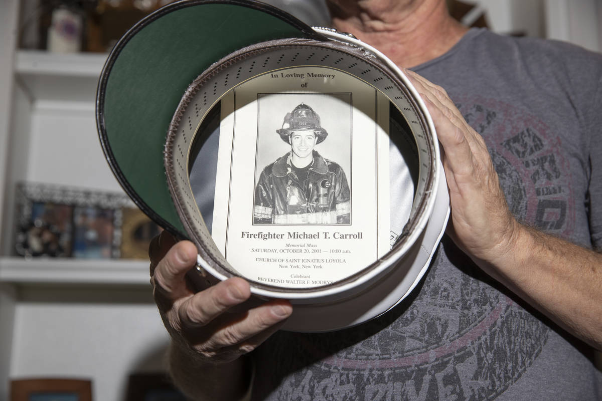 Ed Bergen, a retired New York City firefighter, shows a picture inside of his fire department c ...