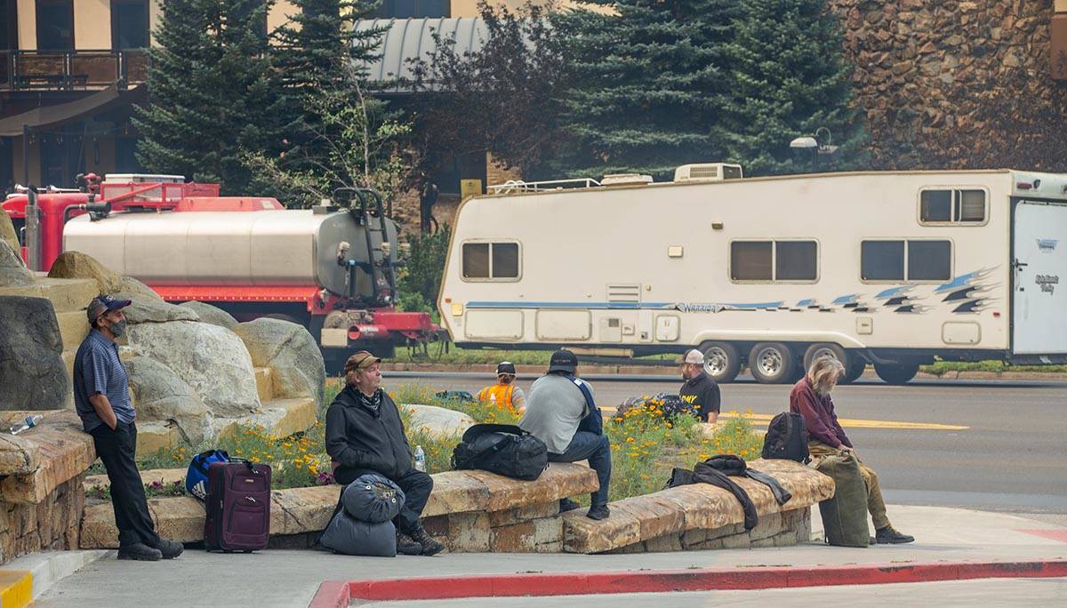 Guests sit outside awaiting a shuttle as the Montbleu Resort, Casino and Spa is now evacuating ...