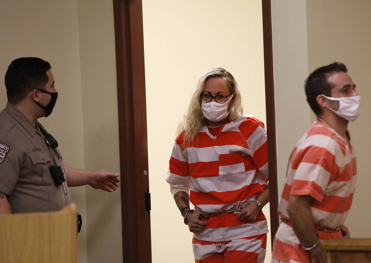 Heather Pate, center, and Kevin Dent, right, enter the courtroom for their hearing at Pahrump J ...