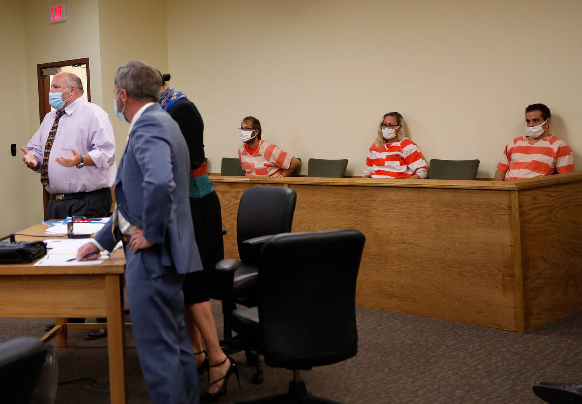 Brad Mehn, background from left, Heather Pate and Kevin Dent listen to Dent's attorney, Jason E ...