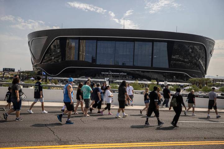 Fans make their way to Allegiant Stadium before the start of an NFL preseason football game bet ...