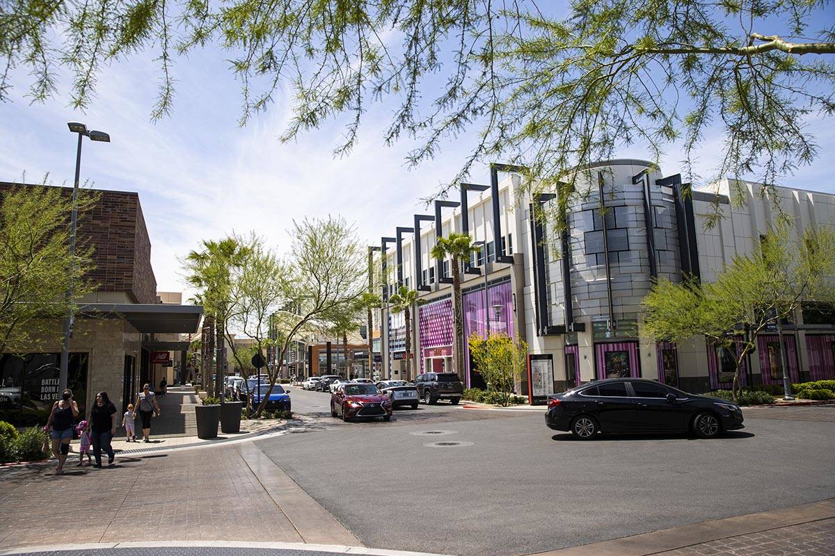 People walk around at Downtown Summerlin as some restaurants and businesses open to customers i ...
