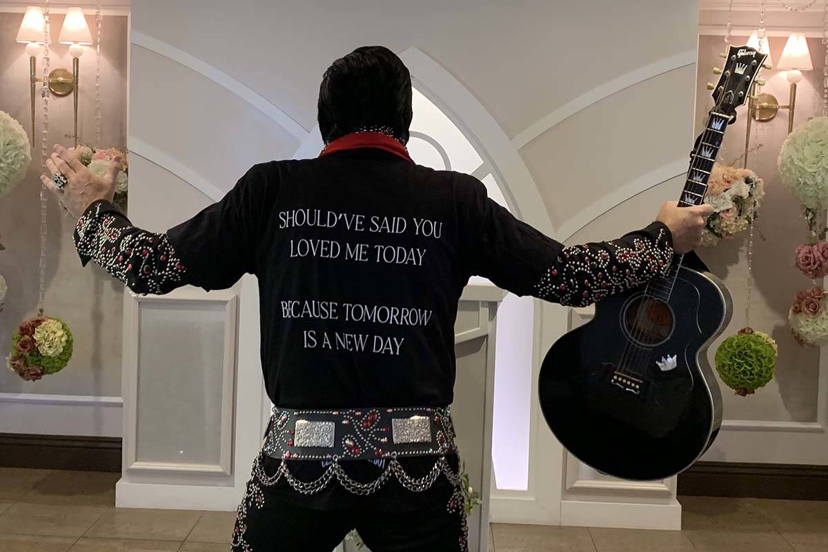 Elvis tribute artist Brendan Paul shows off the T-shirts given away at the Drake “Certif ...