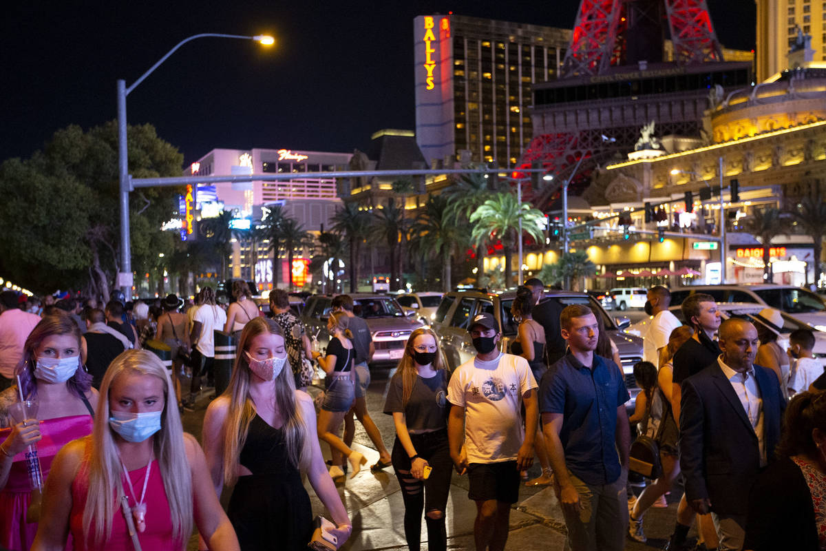 A crowd crosses Bellagio Drive during Labor Day weekend on Saturday, Sept. 5, 2020, on the Las ...