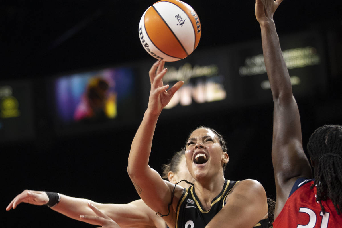 Las Vegas Aces center Liz Cambage (8) slices to the rim past Washington Mystics center Tina Cha ...