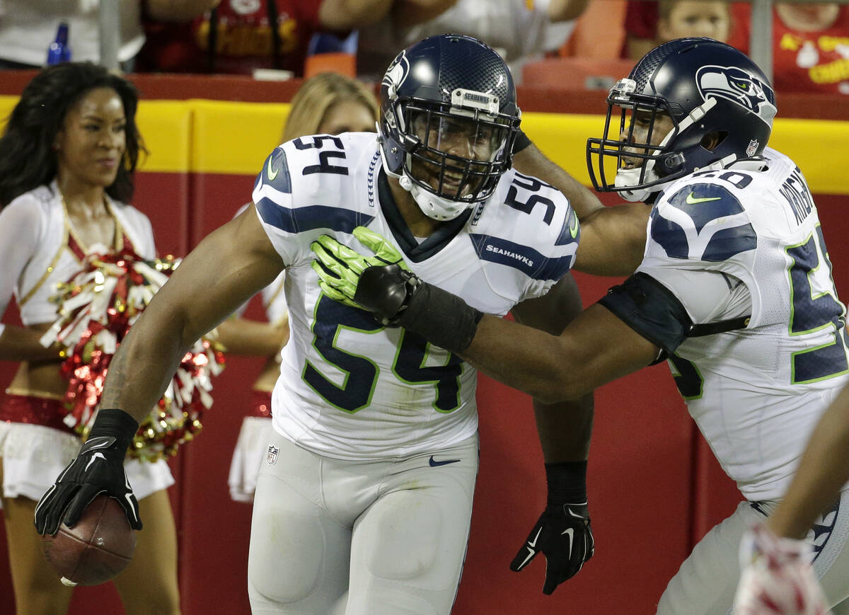 Seattle Seahawks middle linebacker Bobby Wagner (54) celebrates his touchdown with teammate K.J ...